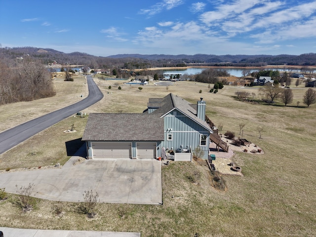 birds eye view of property featuring a water and mountain view