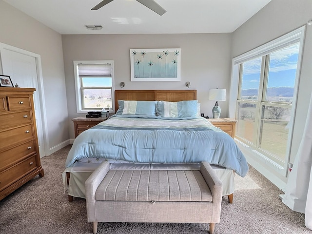 bedroom featuring multiple windows, visible vents, carpet floors, and baseboards