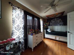 bedroom with hardwood / wood-style floors and ceiling fan