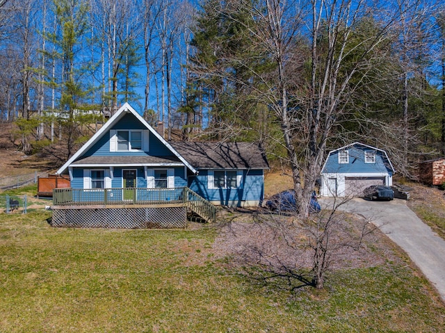 view of front of home with roof with shingles, a chimney, a front yard, a garage, and an outdoor structure