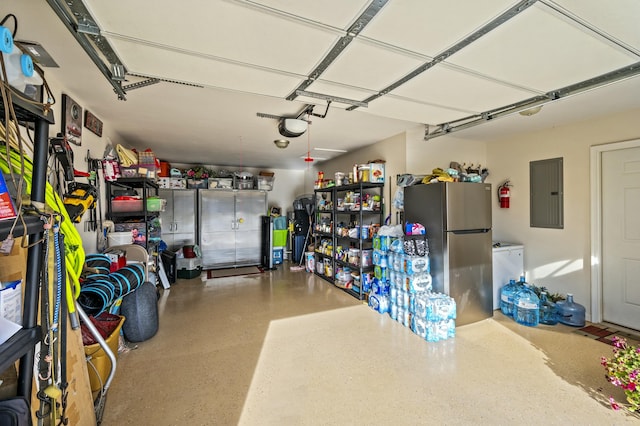 garage featuring stainless steel refrigerator, electric panel, and a garage door opener