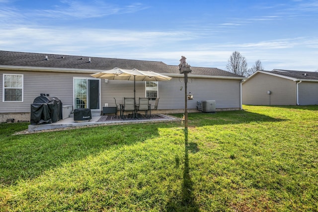 back of house featuring a lawn, cooling unit, and a patio