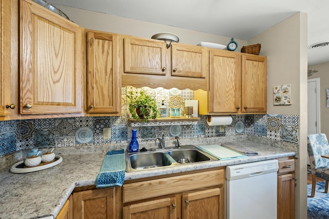 kitchen with dishwasher, tasteful backsplash, and sink