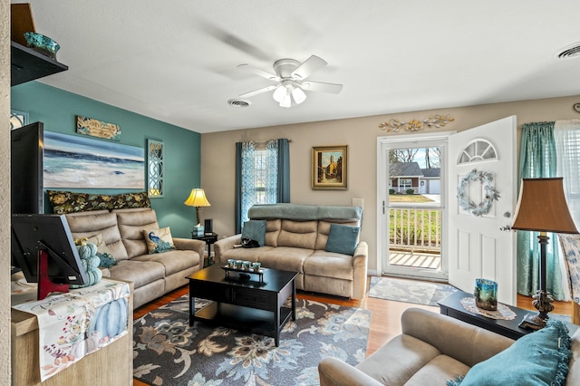 living room featuring ceiling fan and wood-type flooring