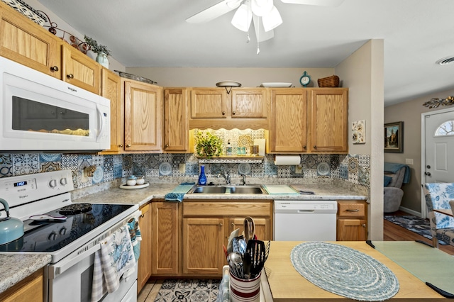 kitchen with backsplash, ceiling fan, sink, and white appliances