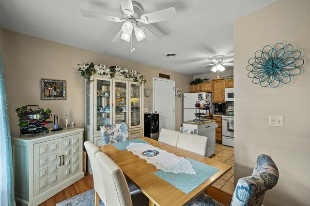 dining space featuring ceiling fan and light tile patterned flooring