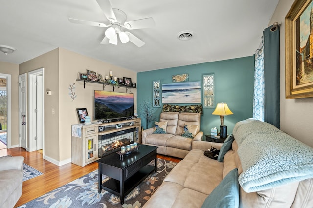 living room with ceiling fan and hardwood / wood-style floors