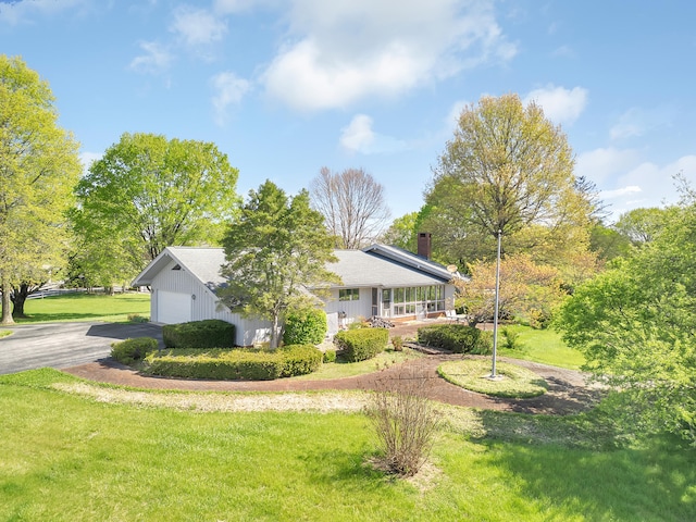 310 Par Ln, Greeneville, TN 37743 - exterior space featuring a porch, a chimney, a lawn, a garage, and aphalt driveway