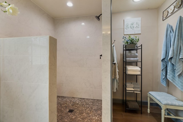 bathroom with a walk in shower, recessed lighting, and wood finished floors