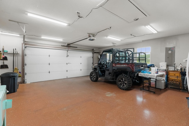 garage featuring electric panel and a garage door opener