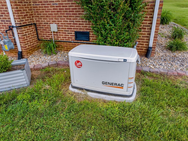 exterior details featuring gas meter, brick siding, and a power unit