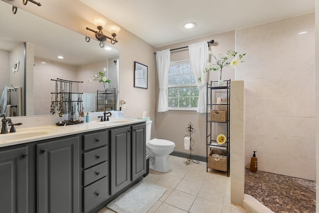 full bathroom with tile patterned floors, a sink, and a walk in shower