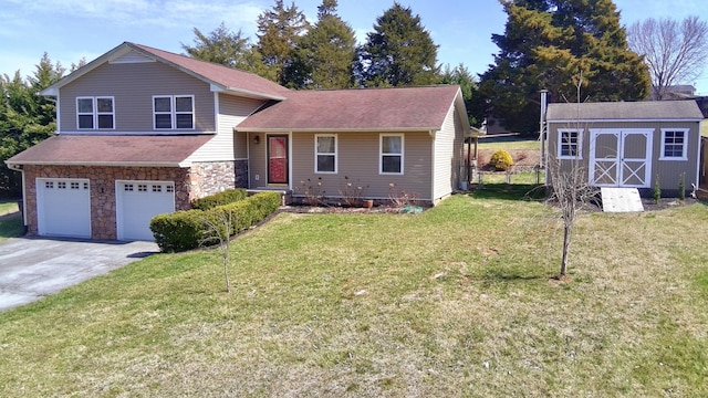 split level home with an attached garage, a front yard, stone siding, driveway, and a storage unit