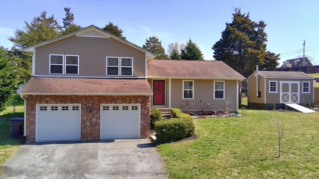 split level home with an attached garage, a front lawn, a storage shed, an outbuilding, and driveway