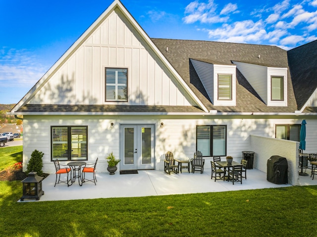 back of property featuring french doors, a patio, and a lawn