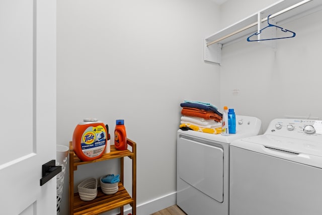 laundry area featuring separate washer and dryer and light wood-type flooring