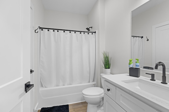 full bathroom featuring vanity, toilet, wood-type flooring, and shower / tub combo