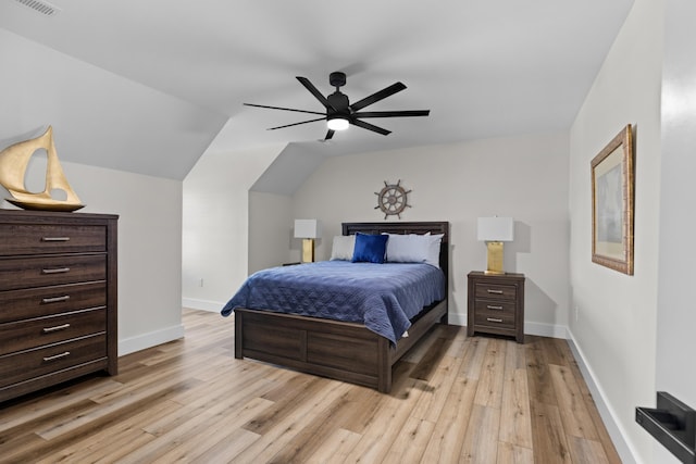 bedroom with light wood-type flooring, vaulted ceiling, and ceiling fan