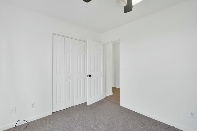 unfurnished bedroom featuring a closet, carpet flooring, baseboards, and ceiling fan