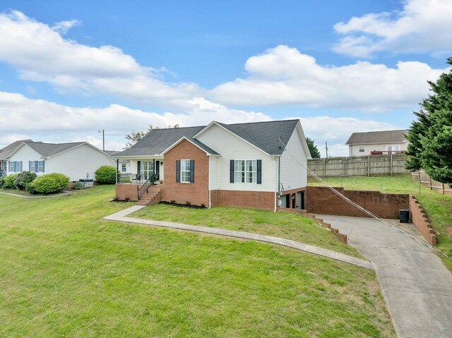 view of front facade with a garage, brick siding, a front yard, and concrete driveway