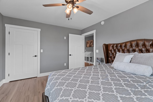 bedroom with wood finished floors, baseboards, and a ceiling fan