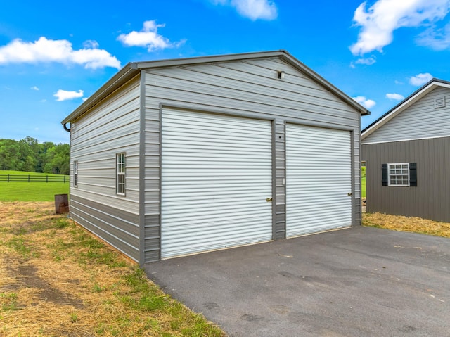 detached garage featuring fence