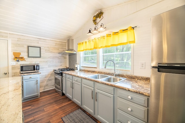 292 Burkhart Rd, Rutledge, TN 37861 - kitchen featuring stainless steel appliances, wall chimney exhaust hood, wooden walls, gray cabinetry, and lofted ceiling