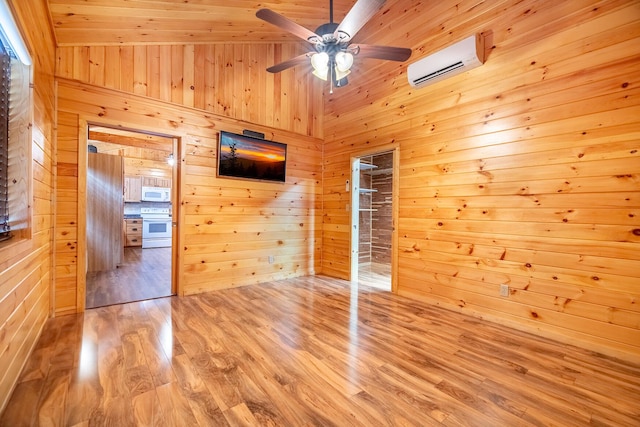 292 Burkhart Rd, Rutledge, TN 37861 - unfurnished bedroom featuring a wall mounted AC, wood walls, and wood finished floors