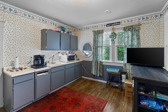 323 Pauline Ave, Morristown, TN 37813 - kitchen with white microwave, dark wood finished floors, wallpapered walls, light countertops, and a textured ceiling