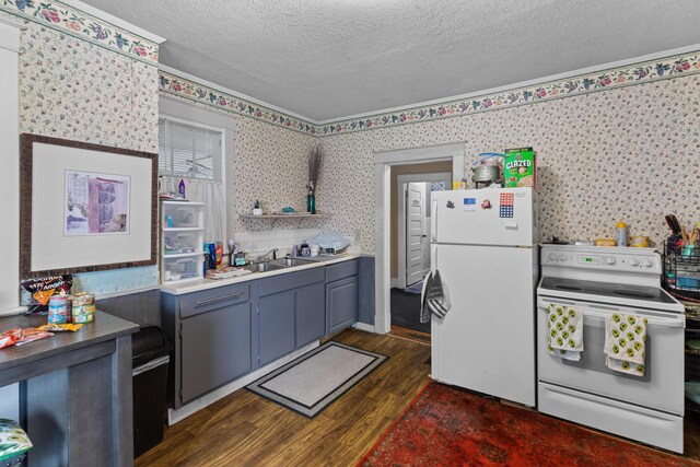 323 Pauline Ave, Morristown, TN 37813 - kitchen featuring white appliances, dark wood finished floors, wallpapered walls, a textured ceiling, and a sink