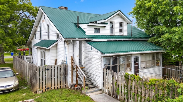 323 Pauline Ave, Morristown, TN 37813 - view of front of house with a chimney, metal roof, fence, and stairs