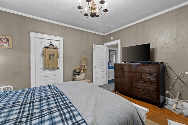 323 Pauline Ave, Morristown, TN 37813 - bedroom featuring a chandelier, a textured ceiling, wood finished floors, and crown molding