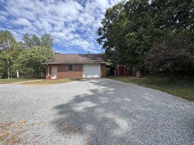 view of front of property with a garage and a shed