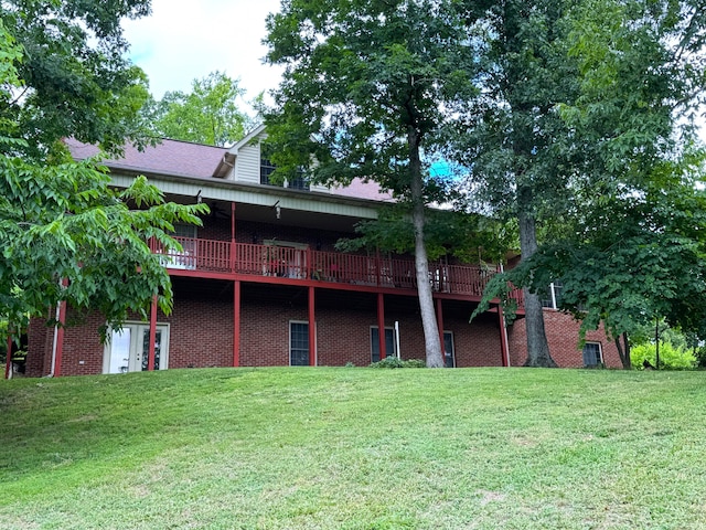 rear view of property with a lawn