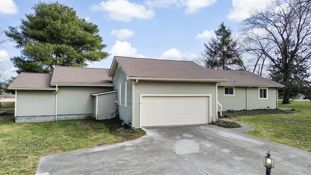 view of side of home with a garage and a yard