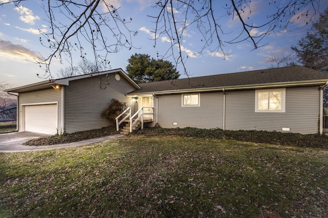 exterior space with a garage and a lawn