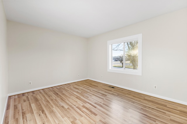 spare room with light hardwood / wood-style floors