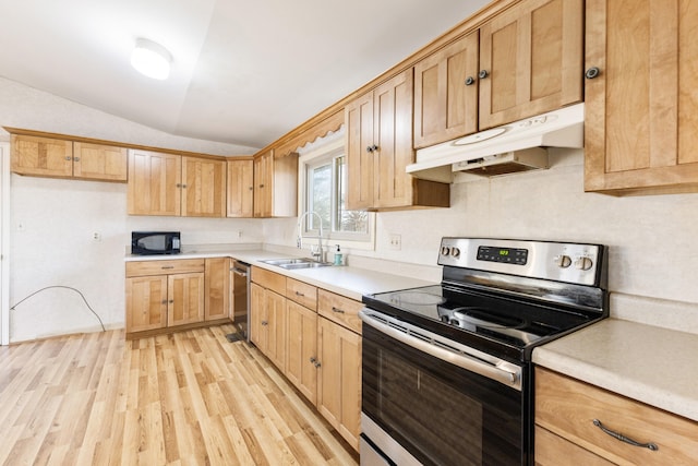 kitchen featuring sink, vaulted ceiling, light hardwood / wood-style floors, and appliances with stainless steel finishes