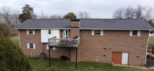 back of house with central AC unit, a lawn, and a deck