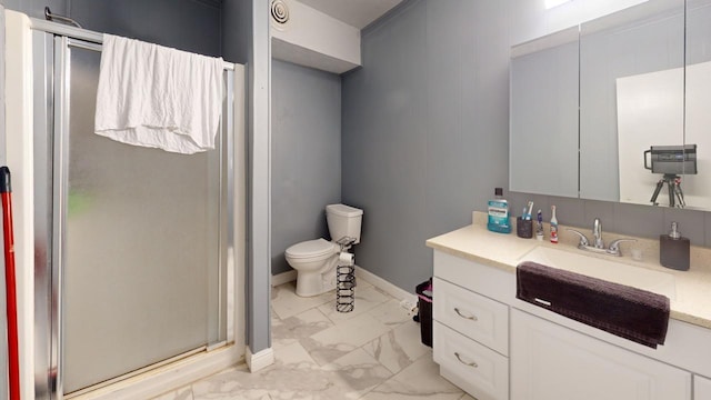 bathroom featuring vanity, toilet, and a shower with shower door