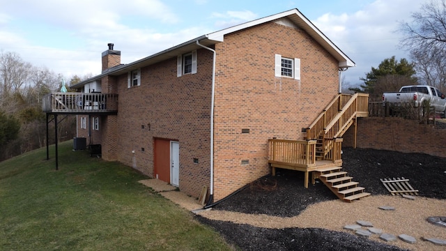 view of home's exterior featuring central AC, a yard, and a wooden deck