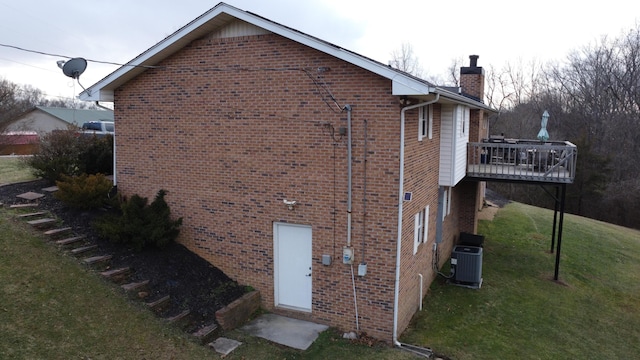 view of home's exterior featuring a yard, central AC, and a deck