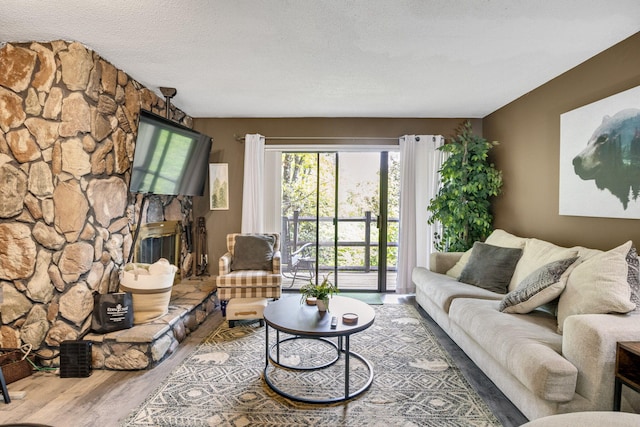 living area with wood finished floors and a textured ceiling