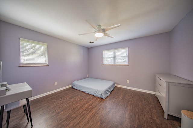 bedroom with ceiling fan and dark wood-type flooring