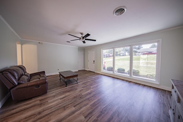 living room featuring dark hardwood / wood-style flooring, ceiling fan, and ornamental molding