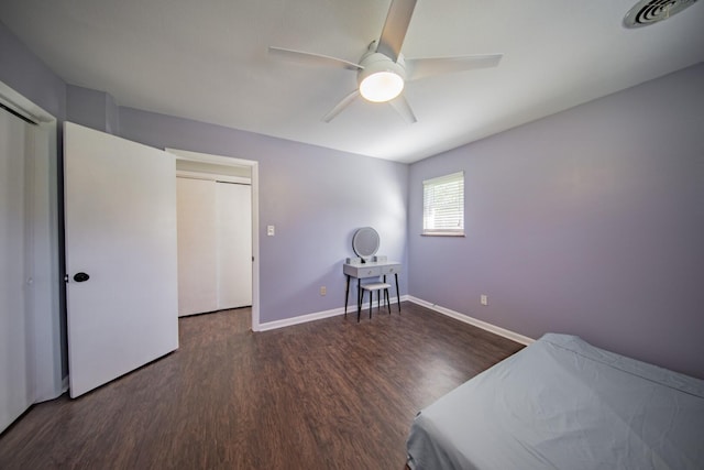 unfurnished bedroom featuring a closet, dark hardwood / wood-style floors, and ceiling fan