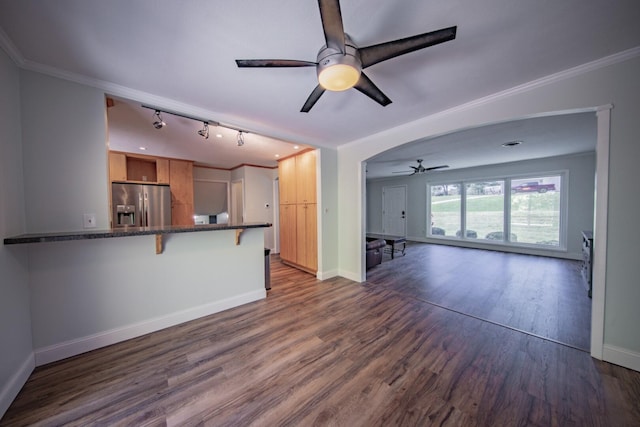 kitchen with a breakfast bar, stainless steel refrigerator with ice dispenser, ornamental molding, dark hardwood / wood-style flooring, and kitchen peninsula