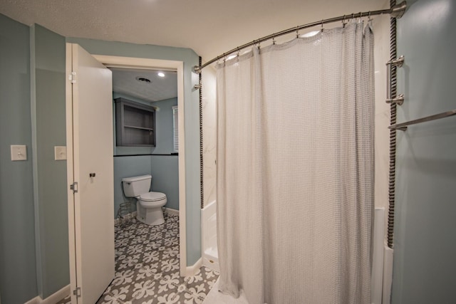 bathroom with a shower with curtain and toilet