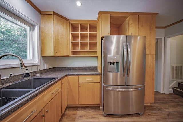 kitchen with crown molding, sink, dark hardwood / wood-style floors, light brown cabinetry, and stainless steel fridge with ice dispenser