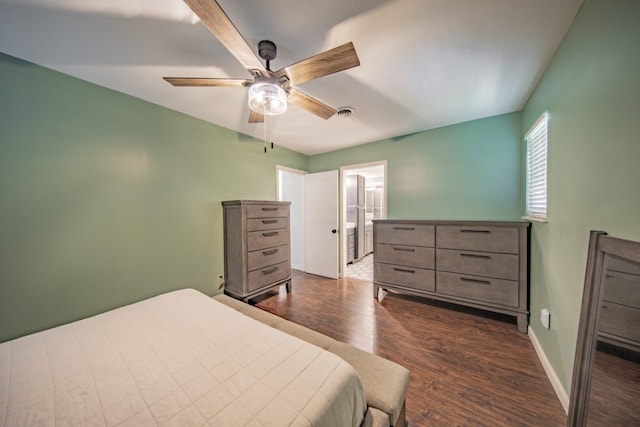 bedroom with ceiling fan, dark hardwood / wood-style flooring, and ensuite bathroom